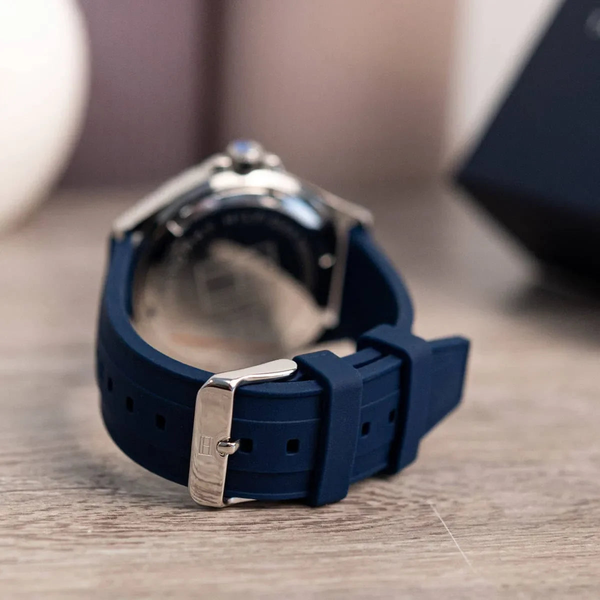 Tommy Hilfiger Logan watch showing navy rubber strap and buckle detail