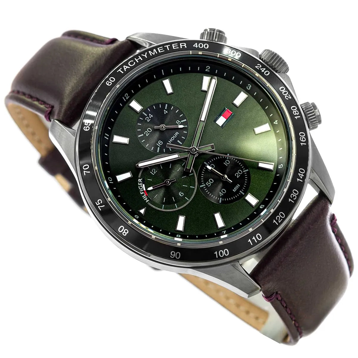 Close-up of Tommy Hilfiger Miles green dial showing hour markers, chronograph subdials, and flag logo
