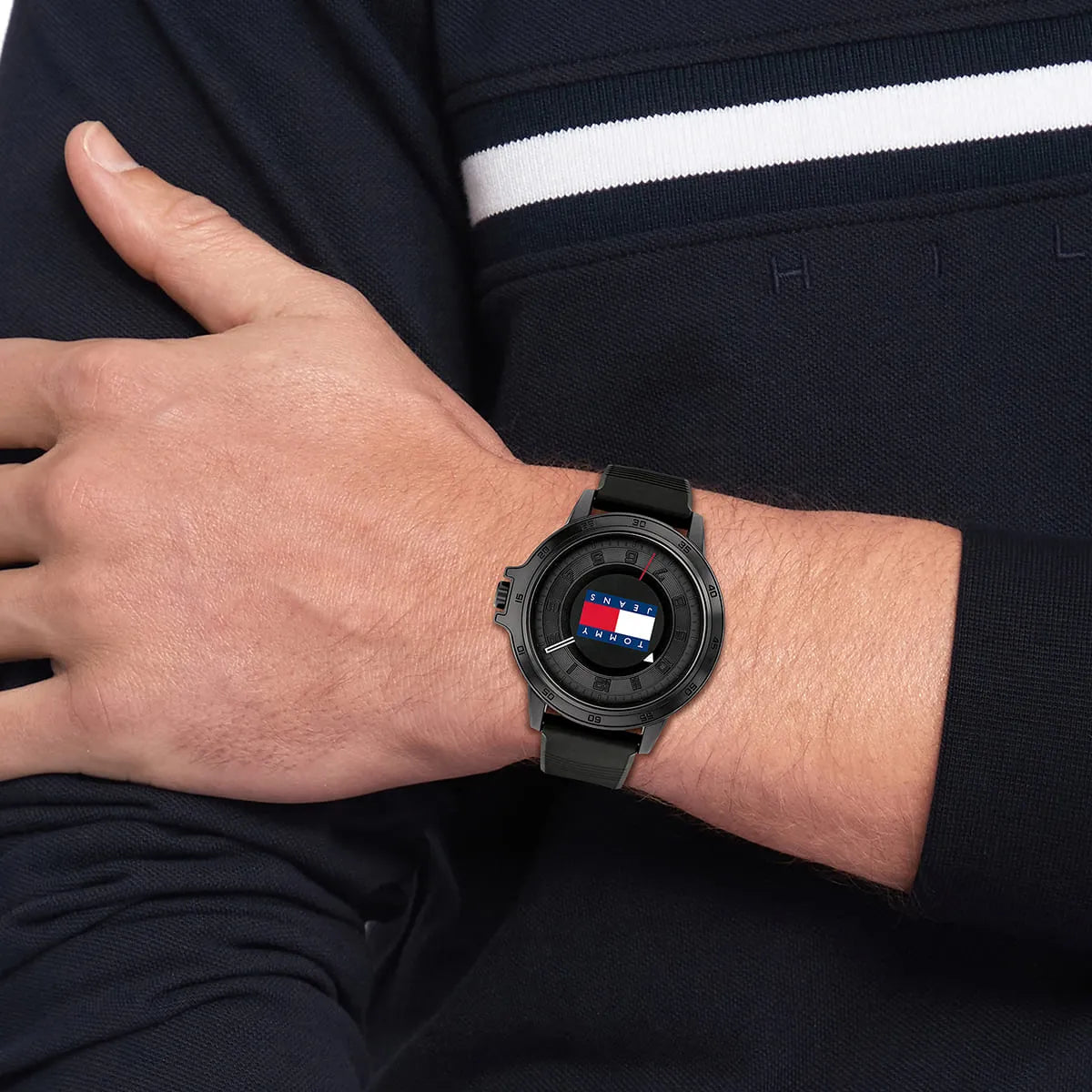 Tommy Hilfiger Jeans watch worn on wrist displaying black dial and silicone strap
