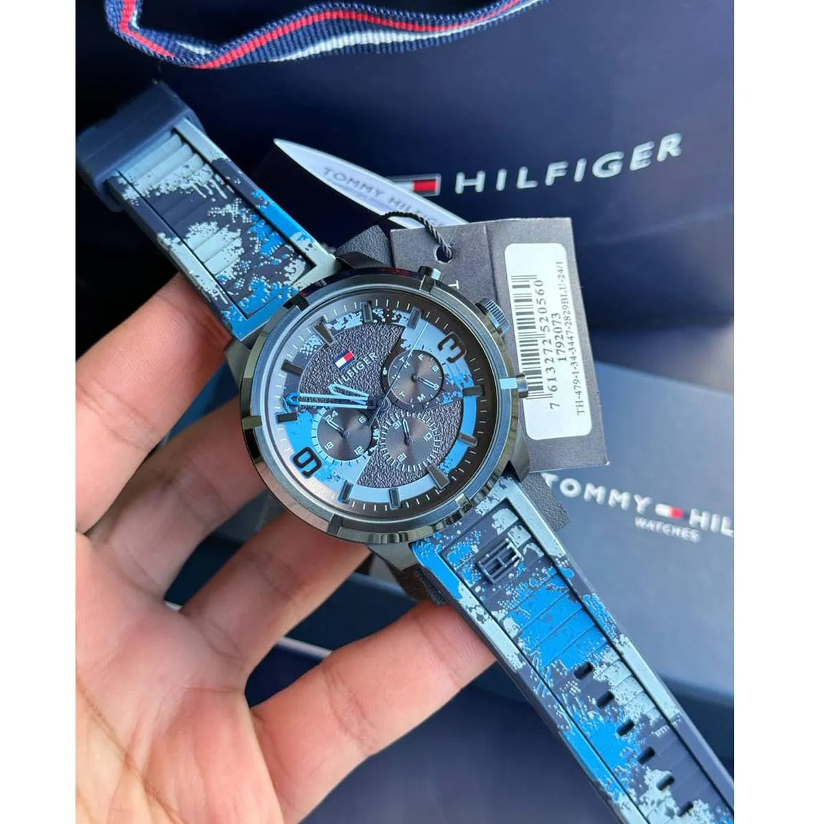 Tommy Hilfiger Wild Blue Chronograph watch in hand with branded presentation box and tag
