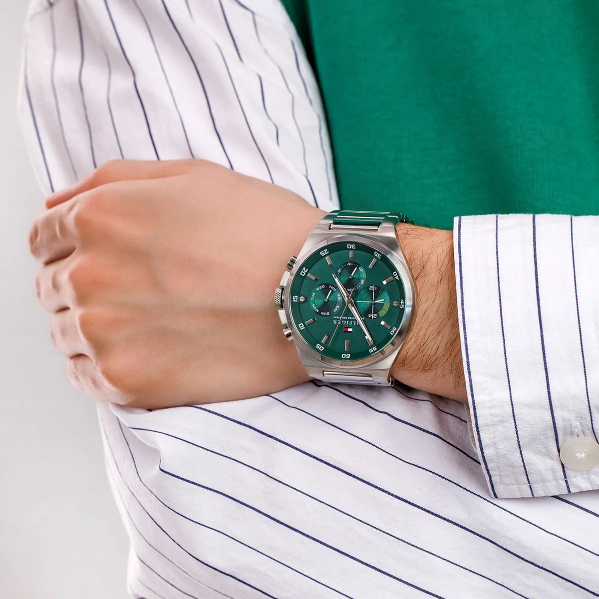 Tommy Hilfiger Dexter watch worn on wrist showing green dial and stainless steel case