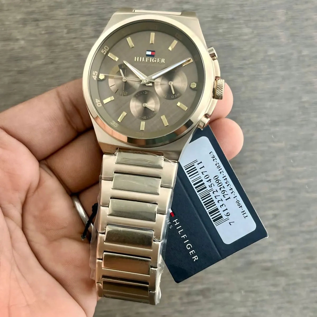 Tommy Hilfiger Dexter gold multifunction watch worn on wrist with product tag