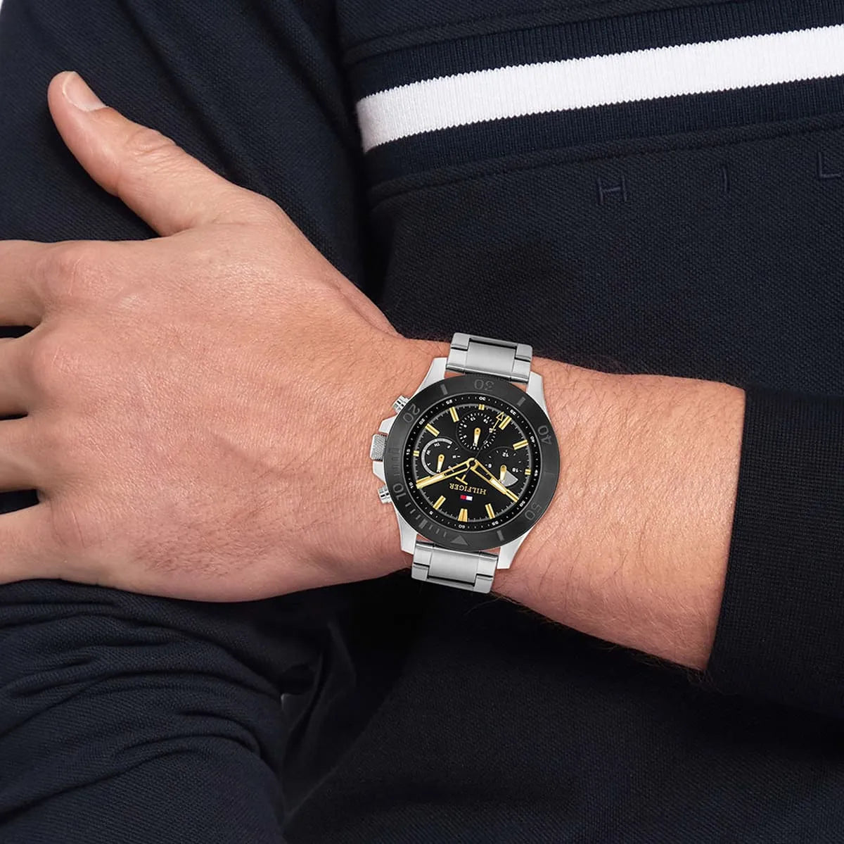Side view of Tommy Hilfiger watch on wrist showing chronograph face with gold hands