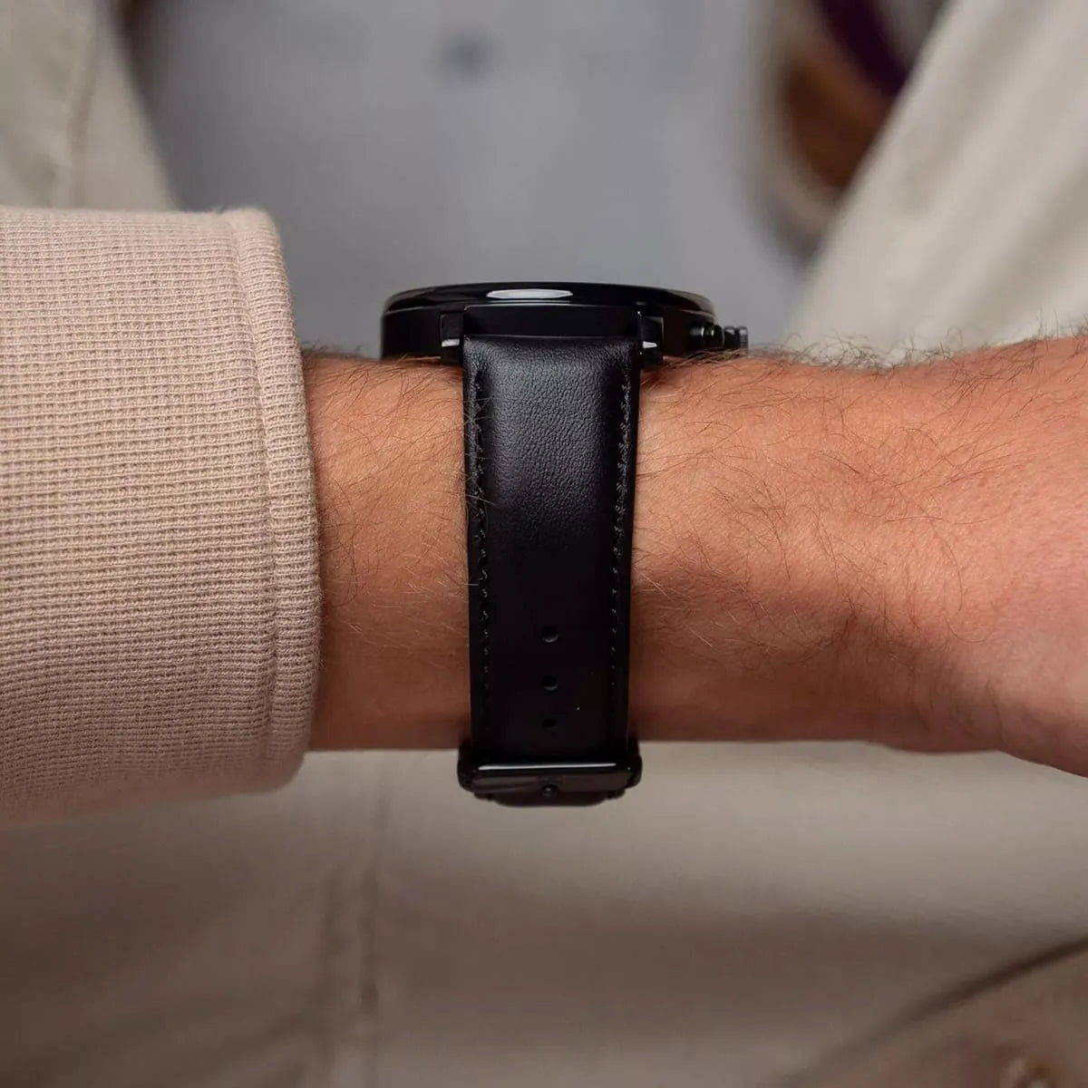 Tommy Hilfiger TYSON black leather watch strap on wrist, showing clasp and stitching detail