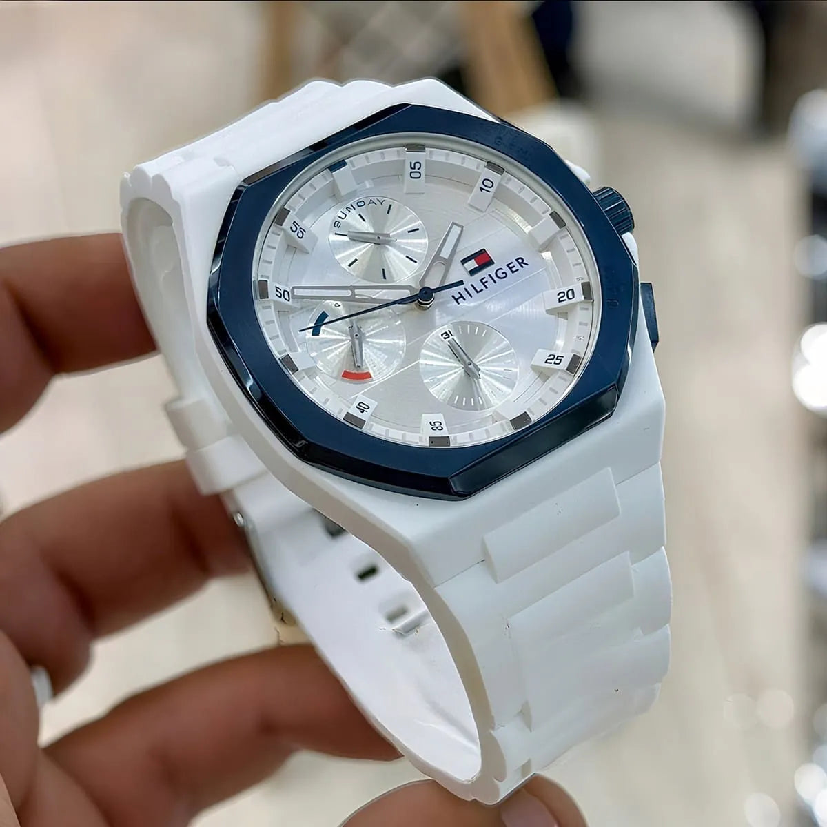 Tommy Hilfiger Neo watch on wrist showing white dial and navy bezel detail