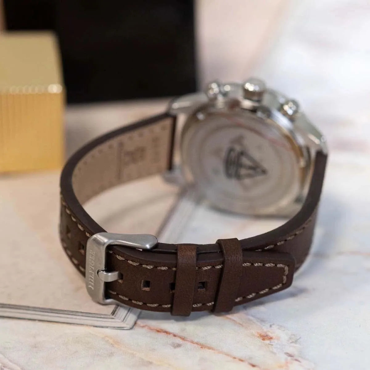 Case back of TH85 watch showing crown and pushers on brown leather strap