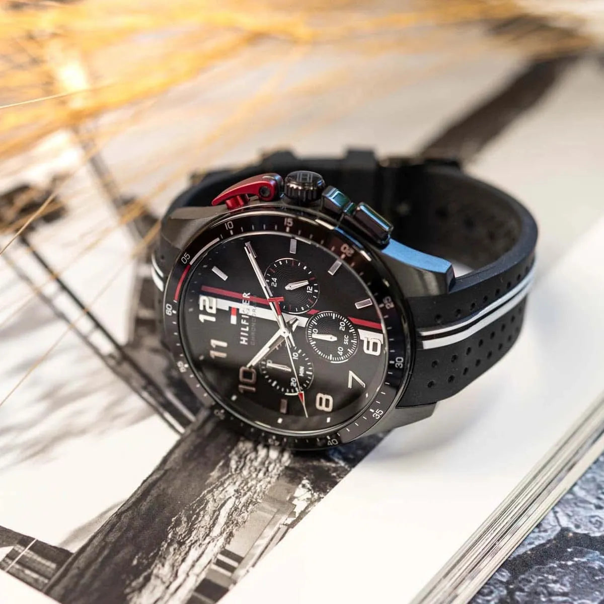 Tommy Hilfiger chronograph men's watch on wrist with black and white striped silicone band
