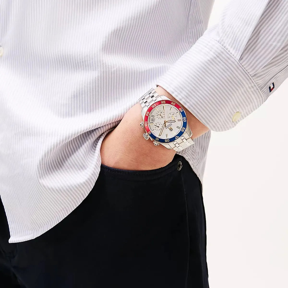 Tommy Hilfiger chronograph watch worn on wrist with white dial and colored bezel