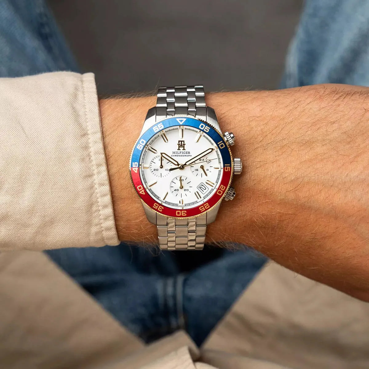 Wrist view of Tommy Hilfiger chronograph watch with stainless steel bracelet on arm