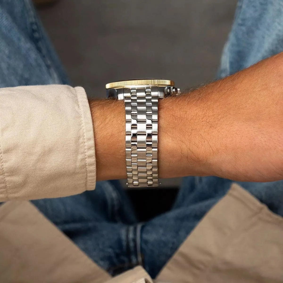 Close-up of stainless steel bracelet and watch case side profile