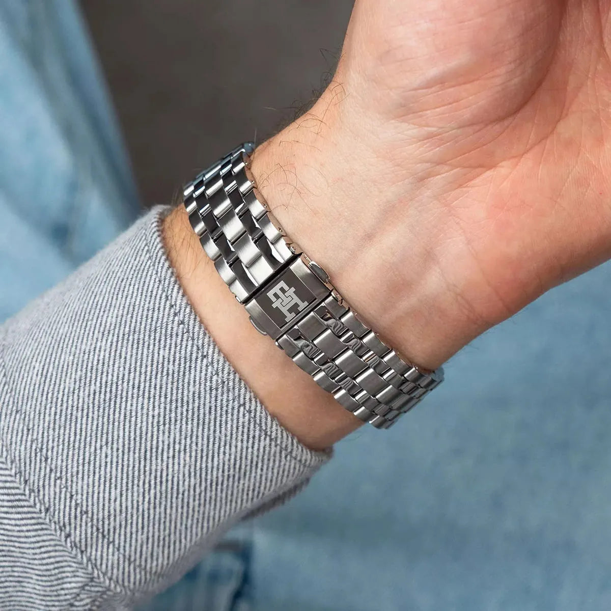 Tommy Hilfiger chronograph watch worn on wrist with stainless steel bracelet