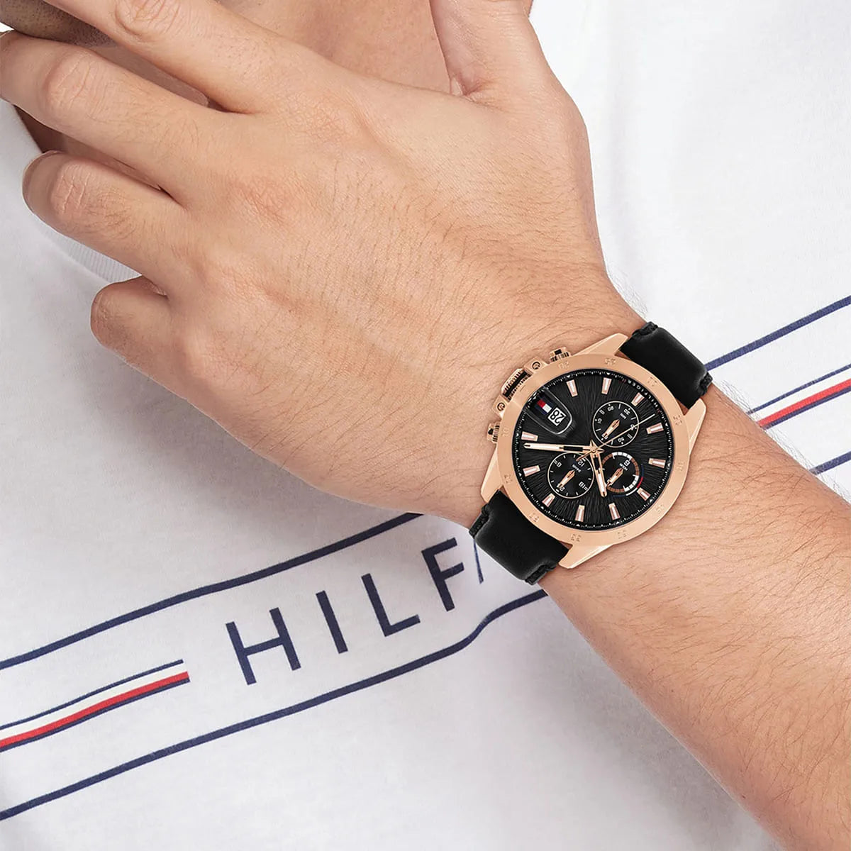 Wrist view of Tommy Hilfiger Jameson watch on male wrist with rose gold case and black dial