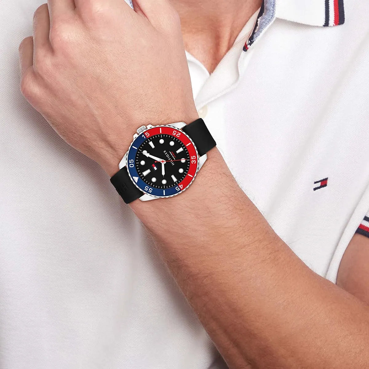 Tommy Hilfiger watch on wrist with white sleeve showing dial detail