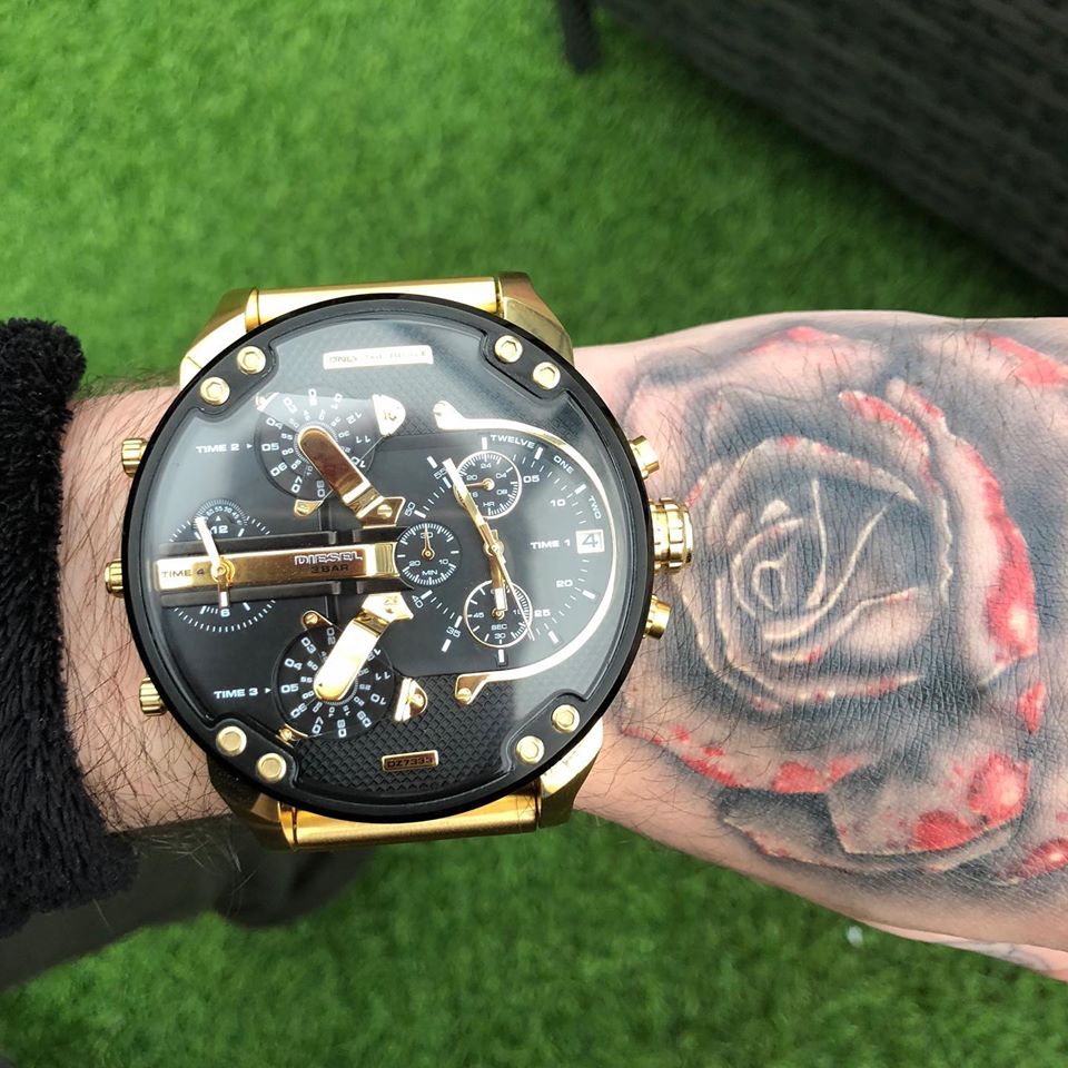 Diesel Big Daddy black dial gold watch worn on wrist with gold-tone bracelet