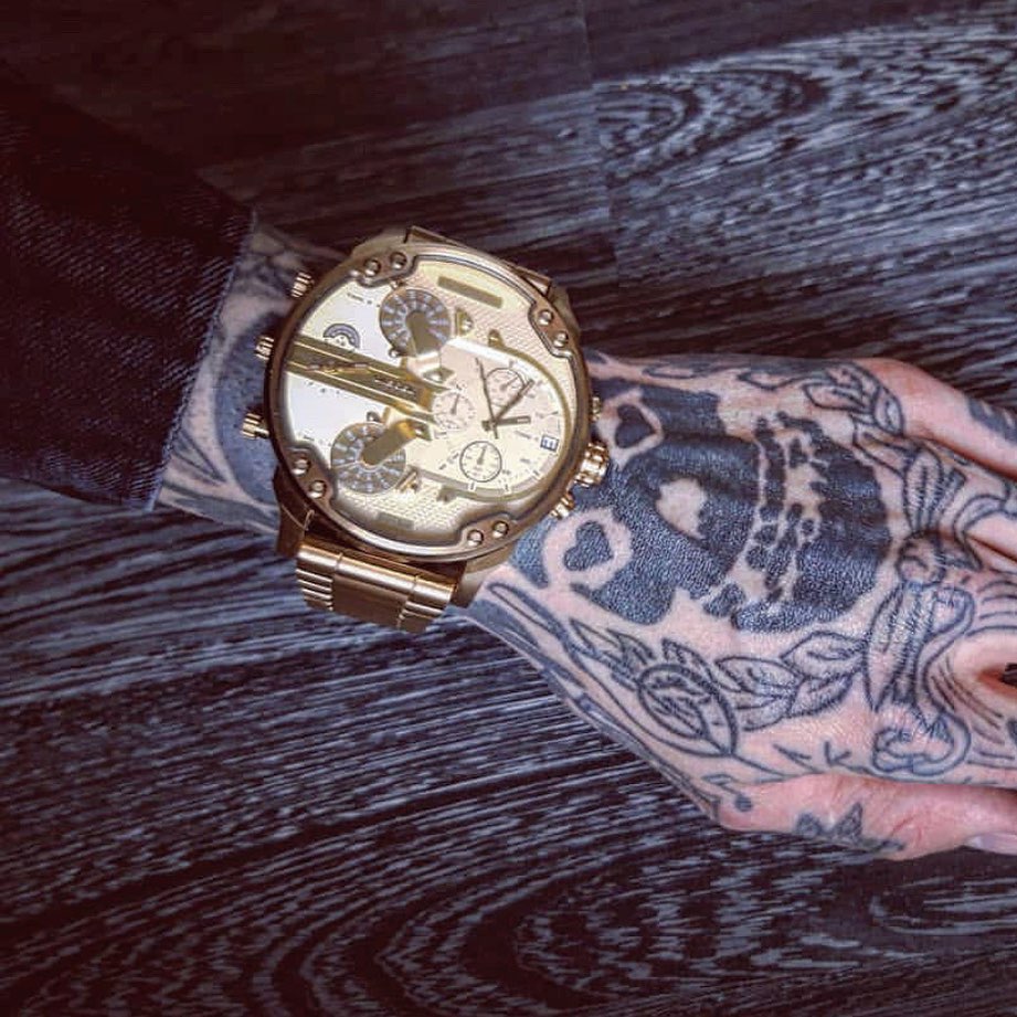 Diesel Big Daddy gold dial gold watch worn on wrist with gold-tone bracelet