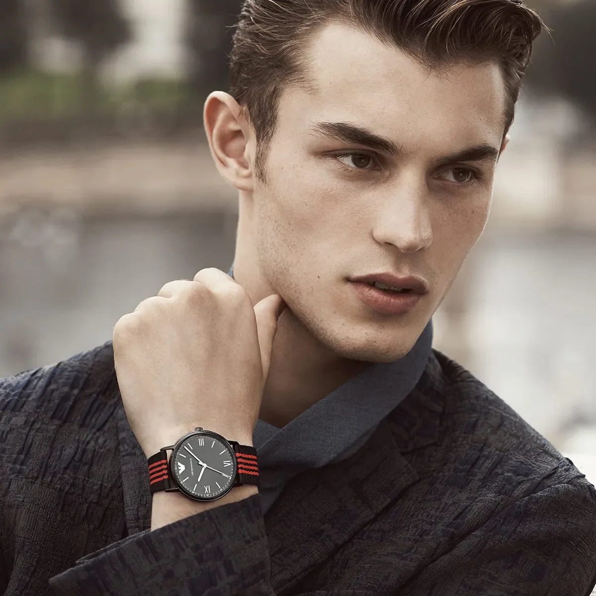 Emporio Armani Kappa AR11015 watch worn on wrist showing black dial and striped strap
