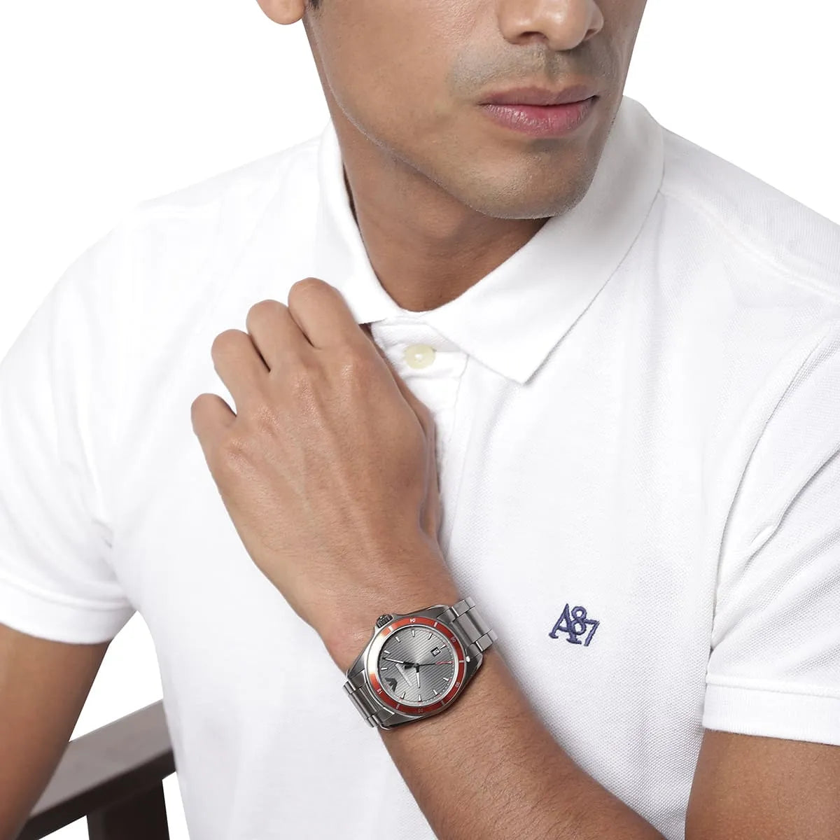 Emporio Armani Sigma men's watch on wrist with white polo shirt, grey dial visible