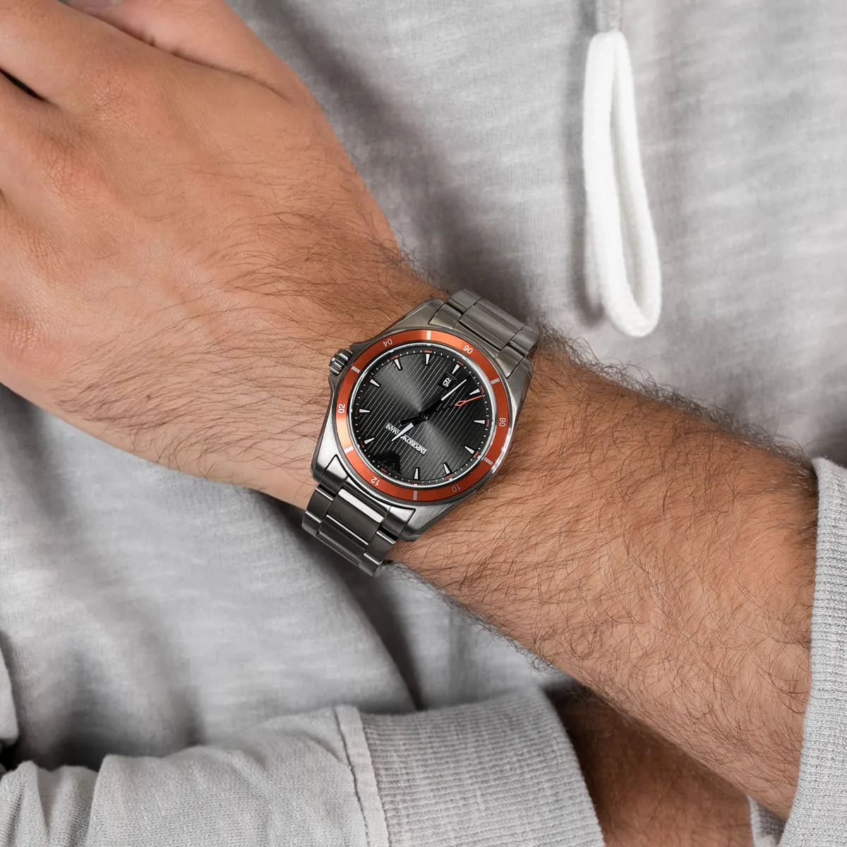 Emporio Armani Sigma watch worn on wrist showing grey dial and orange accents