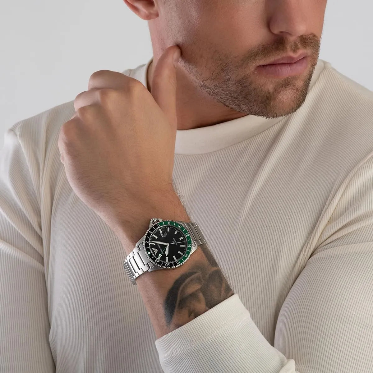 AR11589 Emporio Armani GMT watch worn on wrist with black dial and green bezel