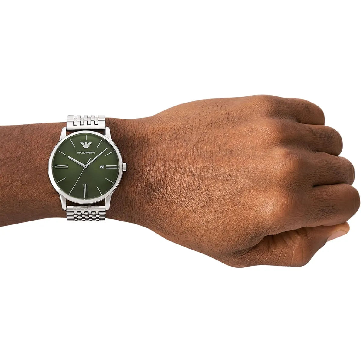 Green dial watch worn on man's wrist showing minimalist design with stainless steel bracelet