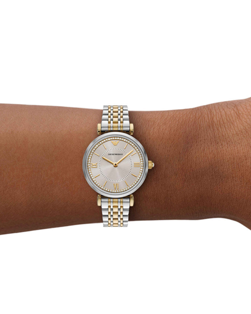 Two-tone Emporio Armani women's watch worn on wrist showing silver dial and mixed metal bracelet