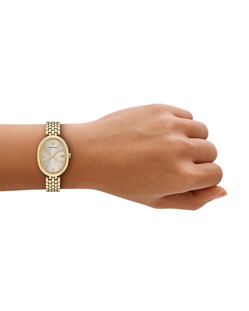 Emporio Armani Sinfonia women's watch worn on wrist, gold-tone oval case with bracelet