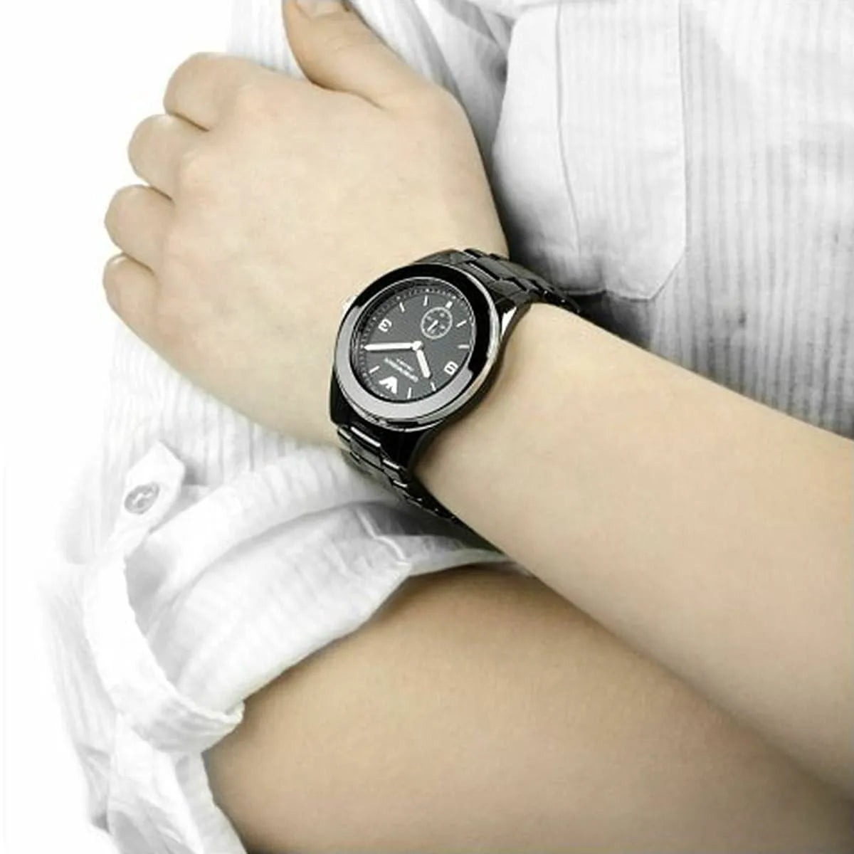 Emporio Armani Ceramica Overseas women's watch worn on wrist with white shirt cuff