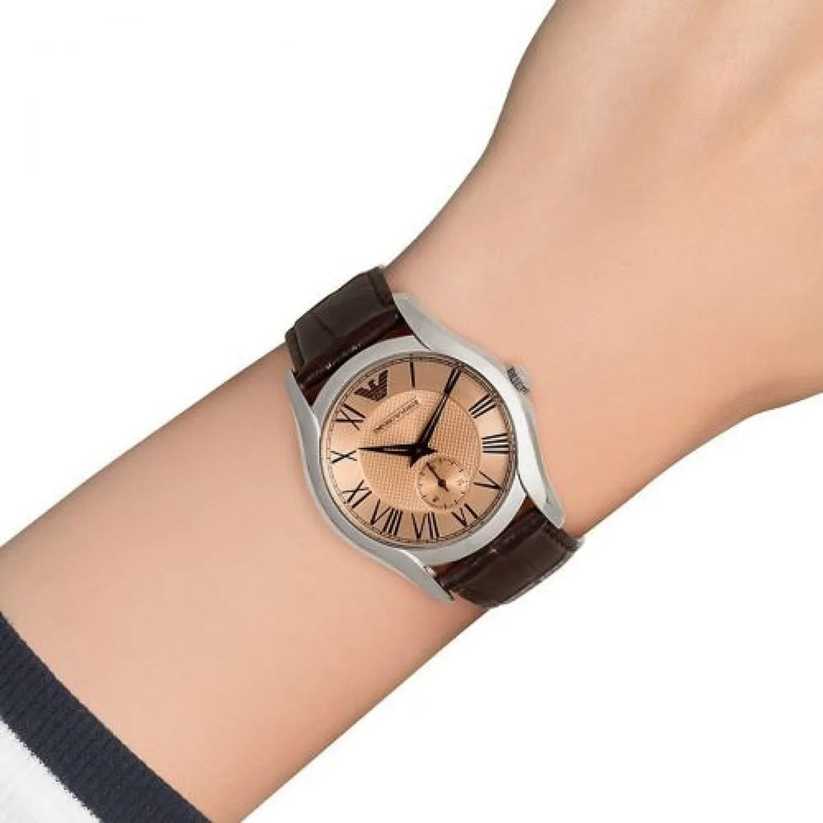 AR1709 worn on wrist showing amber dial with Roman numerals and brown leather strap