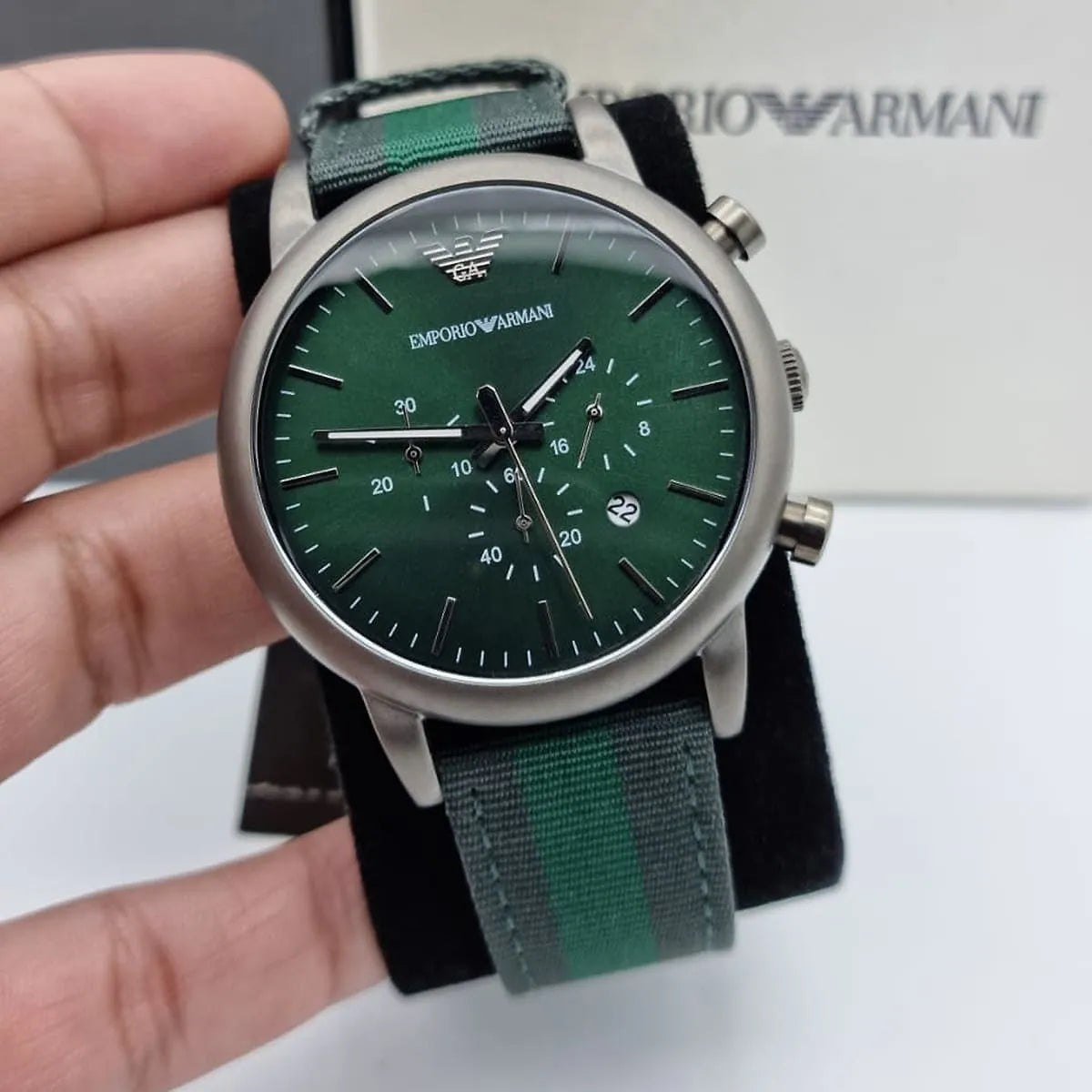 Emporio Armani AR1950 green chronograph watch on wrist with product packaging visible