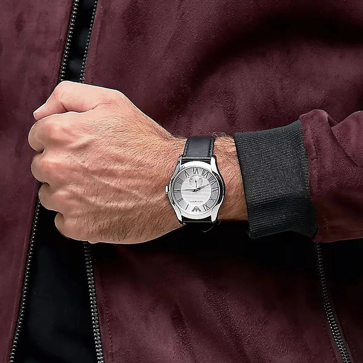 Emporio Armani AR1984 watch worn on wrist with burgundy jacket sleeve