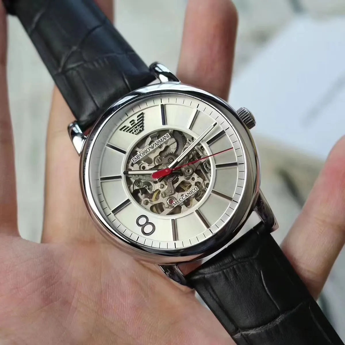 Emporio Armani Meccanico AR1997 automatic skeleton watch worn on wrist with black leather strap
