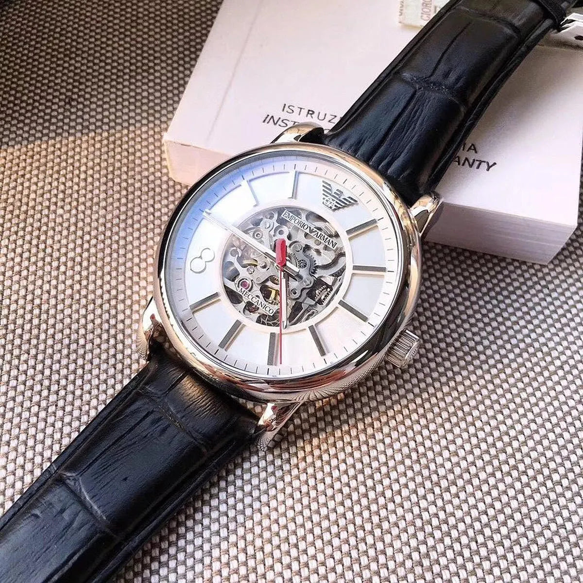 Emporio Armani Meccanico AR1997 on wrist showing silver dial with open skeleton movement