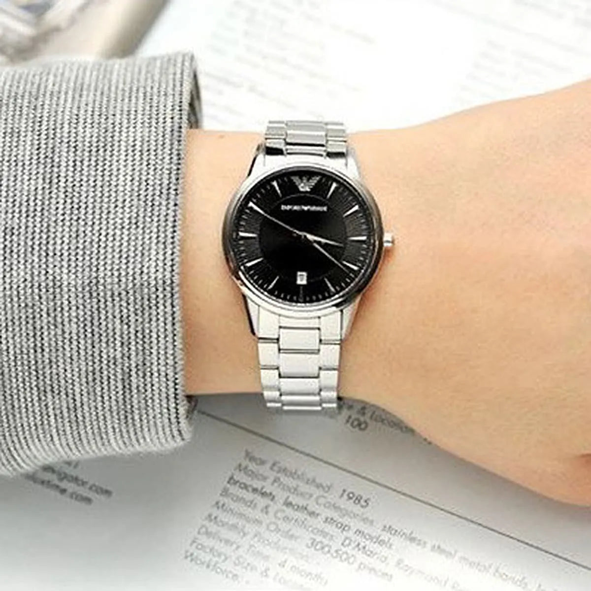Emporio Armani AR2441 watch worn on wrist showing black dial and silver stainless steel bracelet