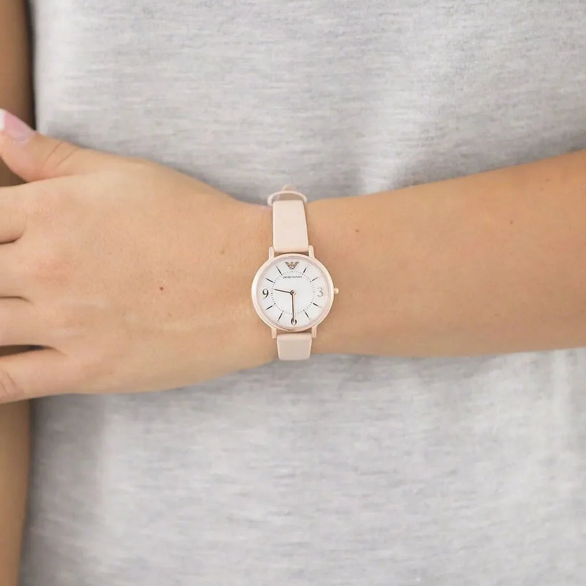 Emporio Armani AR2512 women's watch worn on wrist showing mother-of-pearl dial and beige leather strap fit