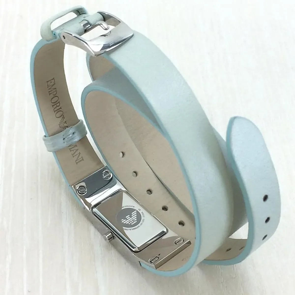 Double-wrap leather strap detail showing metal hardware and buckle closure on AR7355