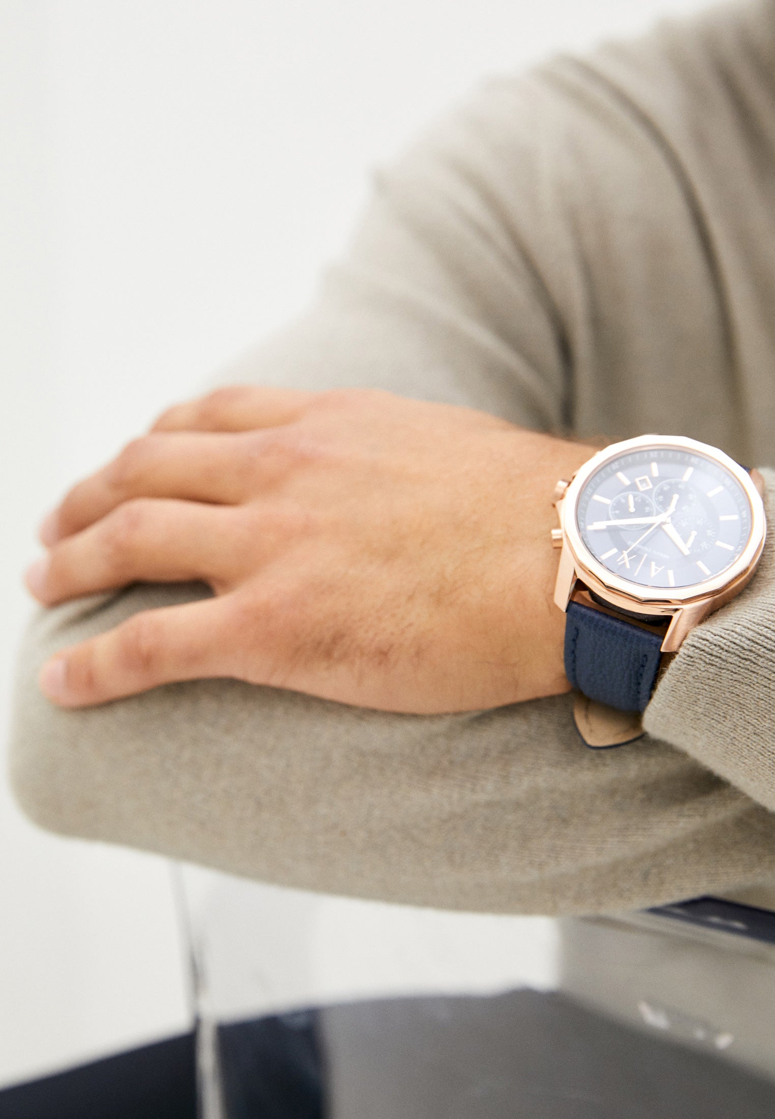 Armani Exchange Banks chronograph watch worn on wrist with blue dial and rose gold case