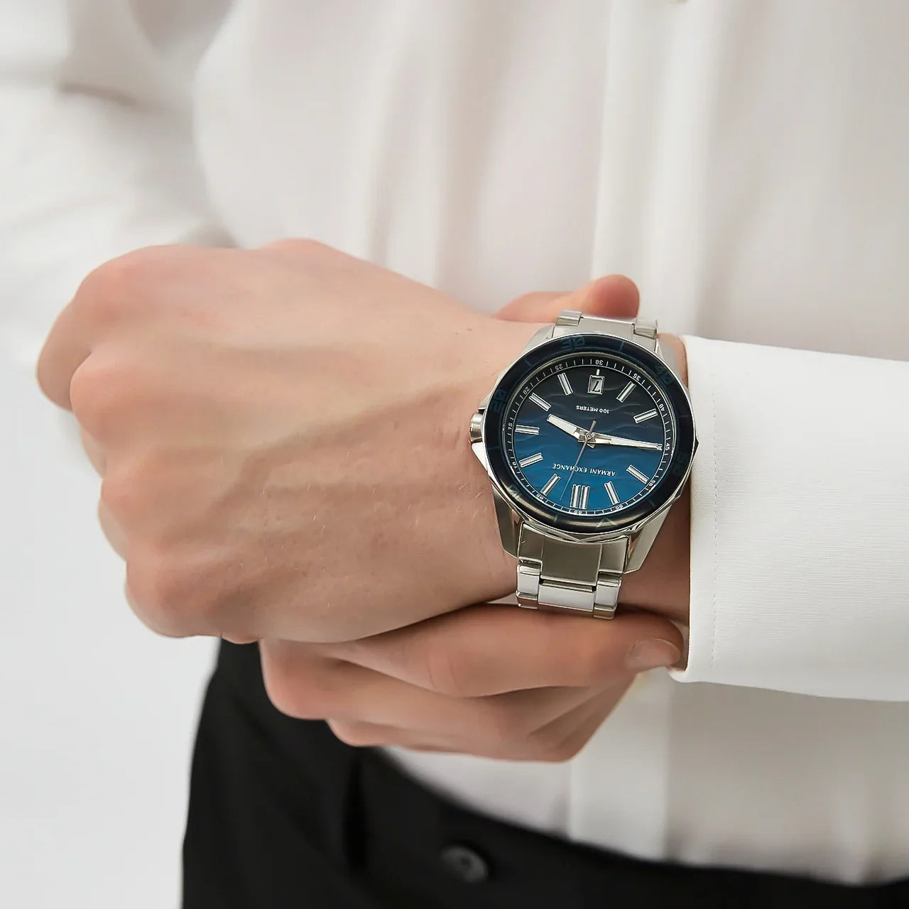 Armani Exchange Spencer watch worn on wrist with ocean blue dial visible