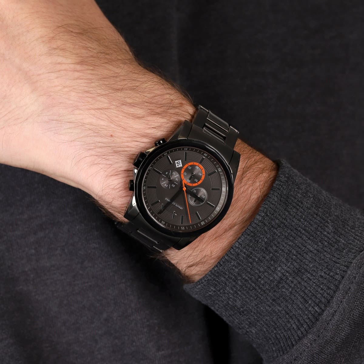 Armani Exchange AX2514 watch on wrist showing grey dial with orange chronograph subdial detail