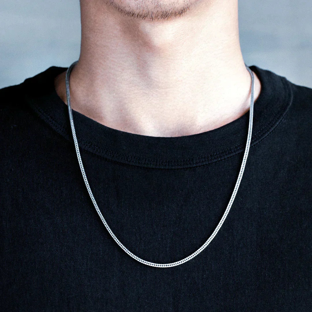 Man wearing Big Daddy 2.5mm rope silver chain around neck on black t-shirt