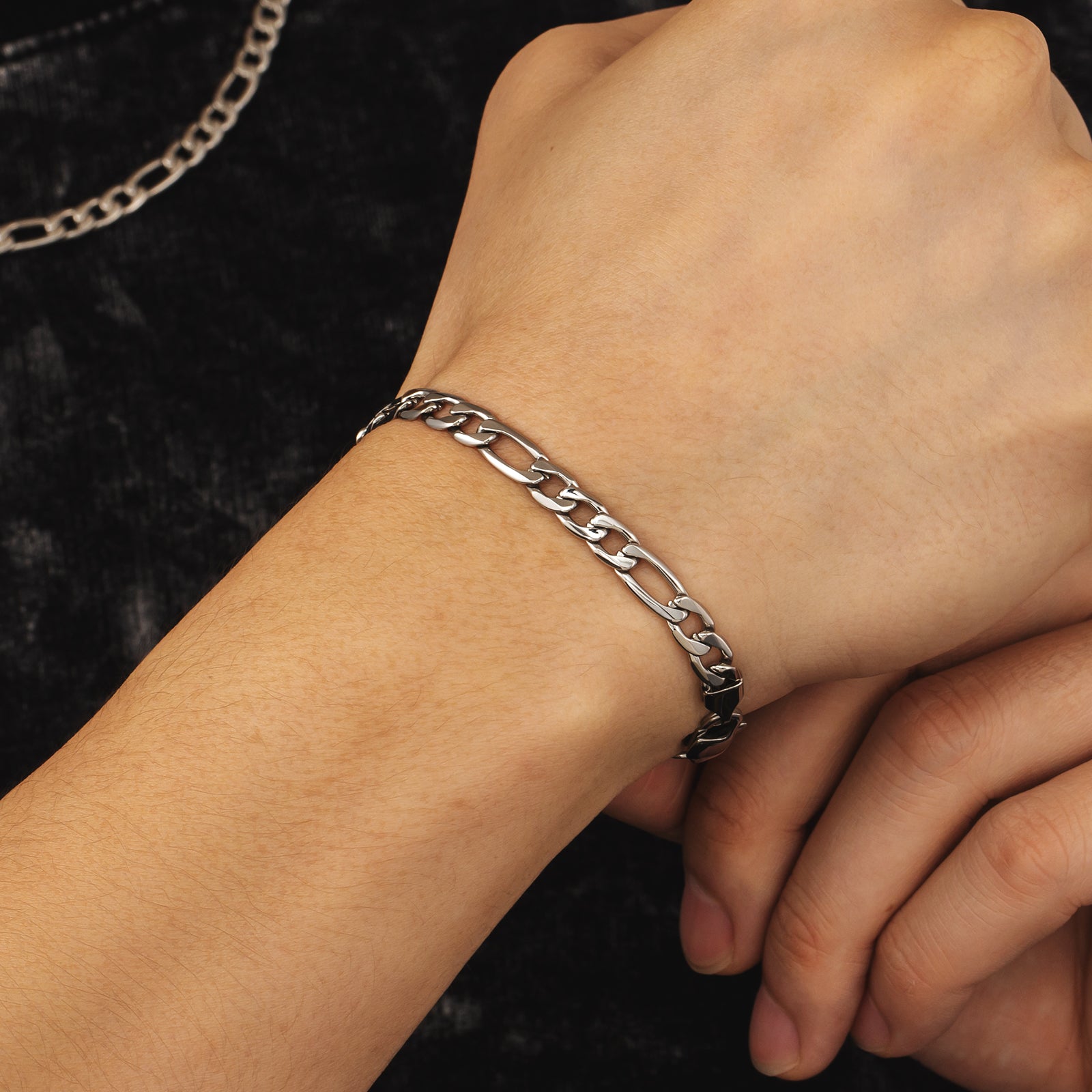 6mm steel figaro silver bracelet worn on wrist showing link pattern and fit