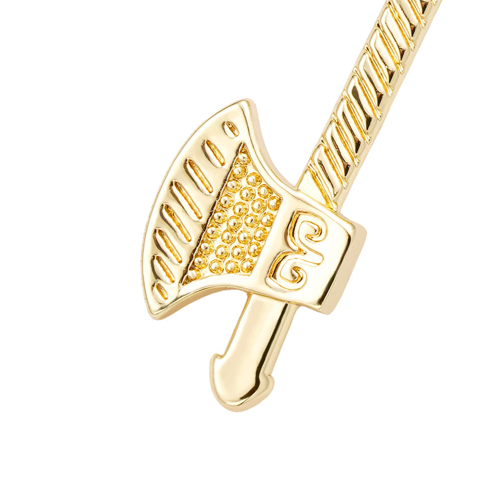 Close-up of gold axe pendant with textured blade and shaft detail