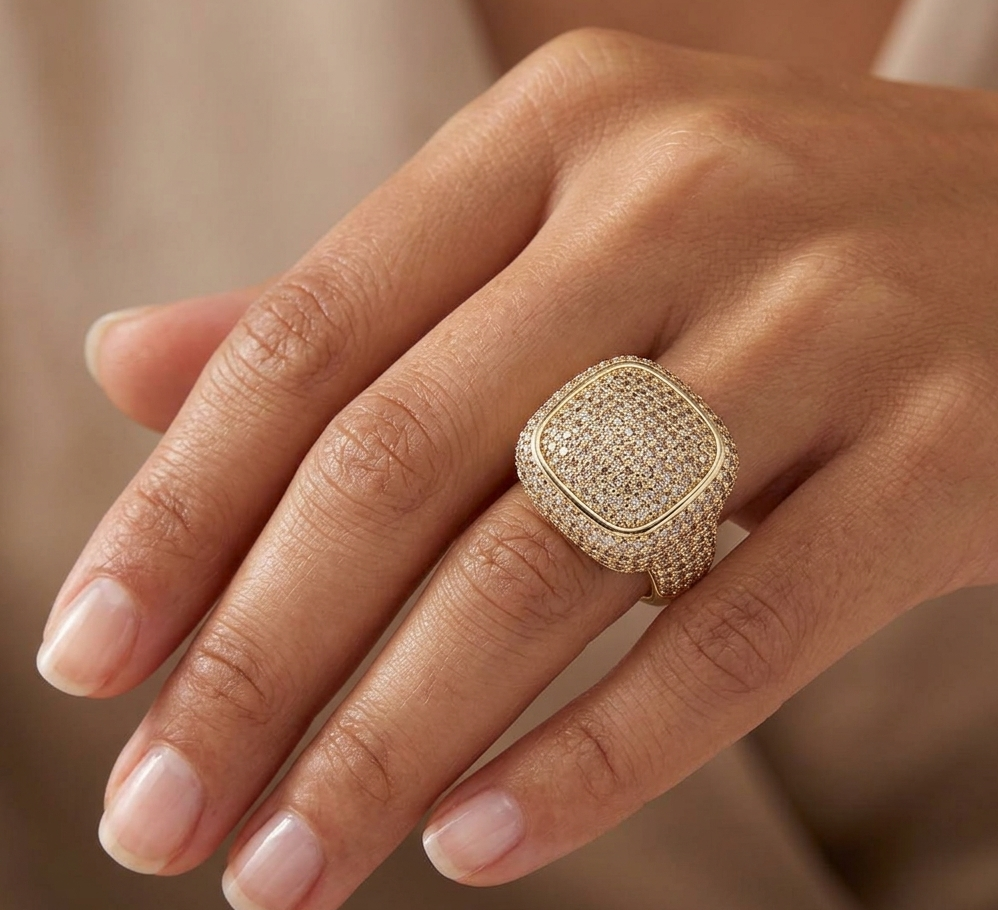 Clustered diamond ring worn on hand, showcasing cushion-shaped dome face with pave setting