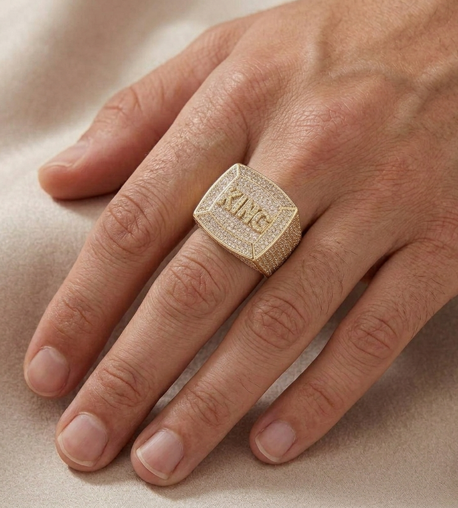 Iced out diamond ring worn on finger showing KING engraving on square face