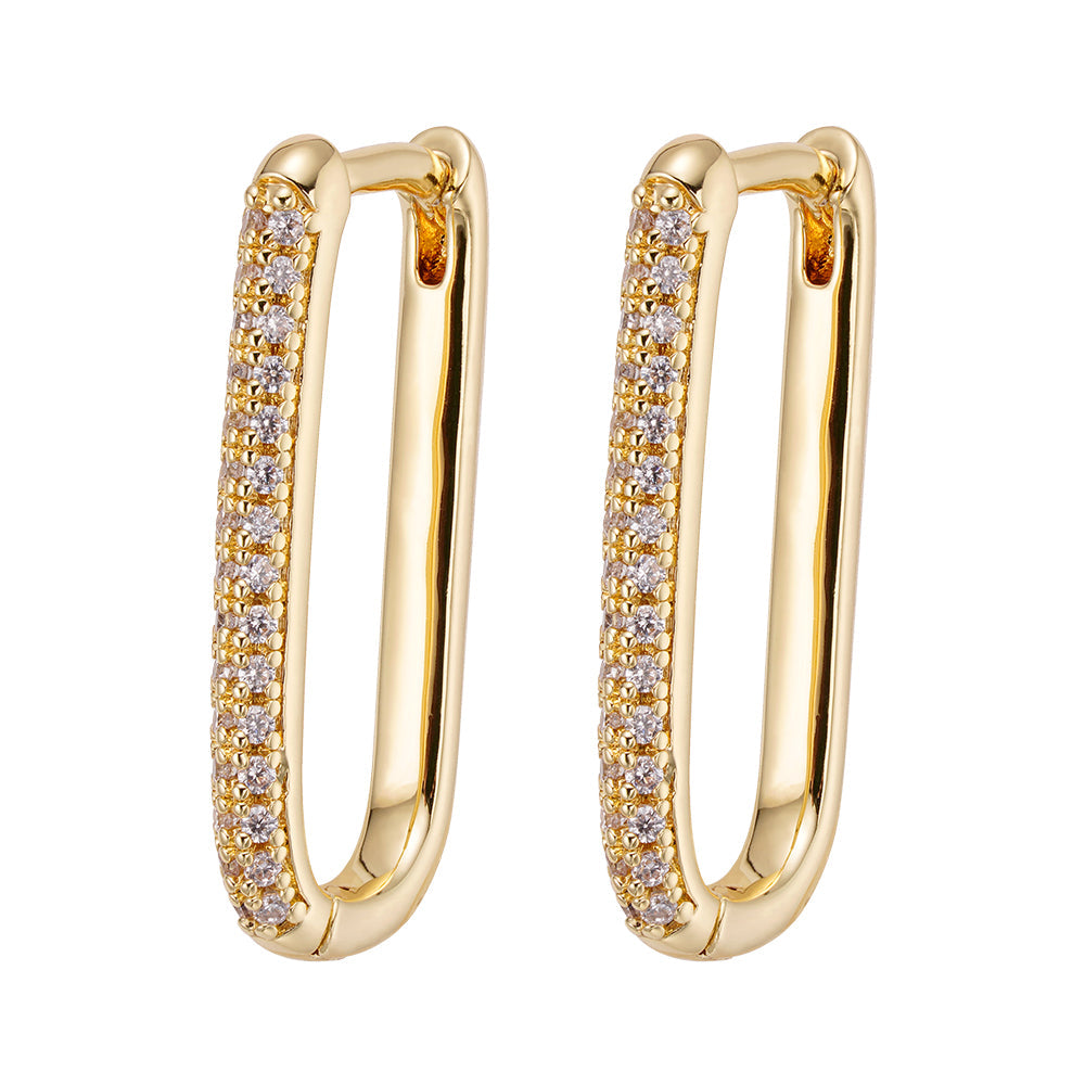 Pair of gold oval loop hoop earrings with cubic zirconia crystals on one side