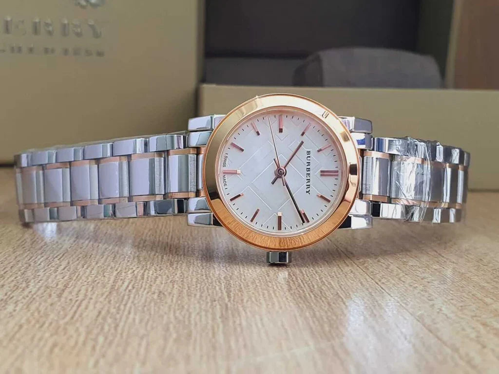 Burberry City Check watch on flat surface showing full two-tone stainless steel and rose gold bracelet
