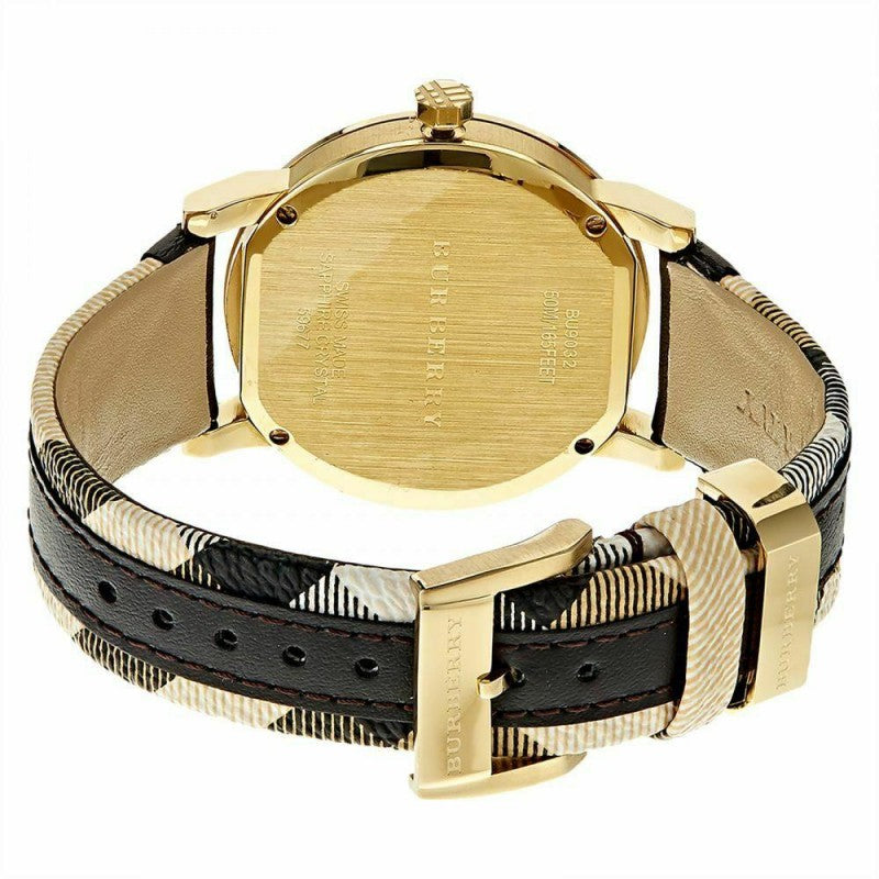 Back view of Burberry The City watch showing gold-tone caseback and black leather strap with Burberry pattern