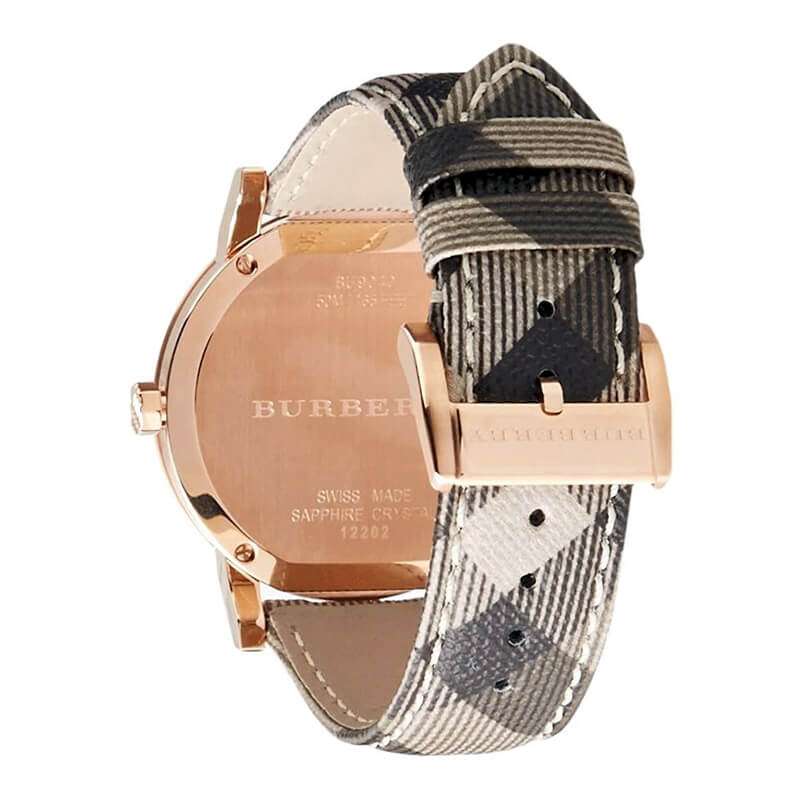 Burberry The City caseback showing rose gold case back and patterned fabric strap