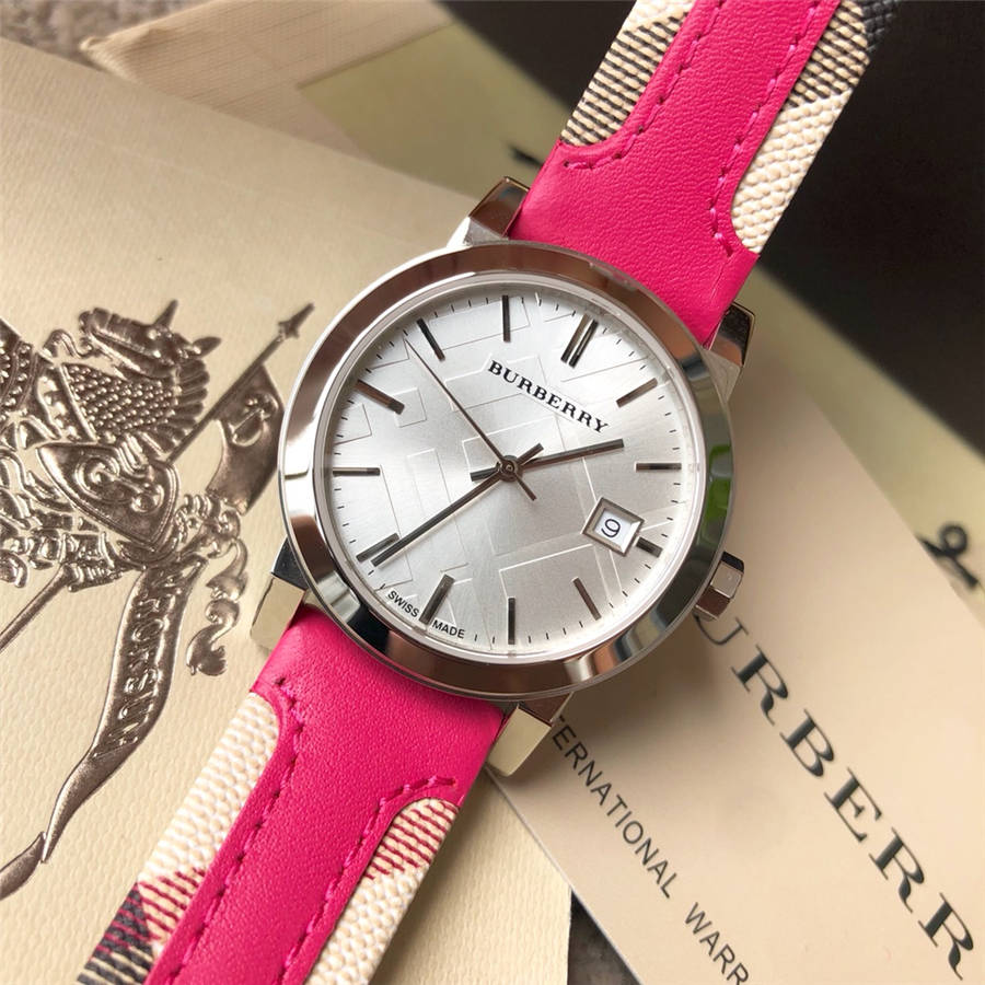 Burberry The City watch on wrist showing silver case and pink Haymarket strap detail