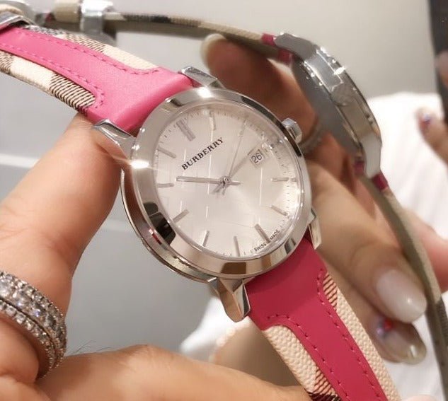 Burberry The City women's watch on wrist with silver case and pink leather band