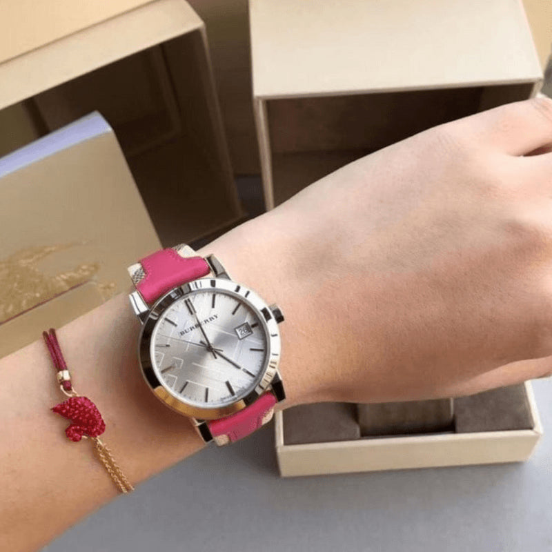 Burberry The City watch on wrist with white dial and pink leather strap